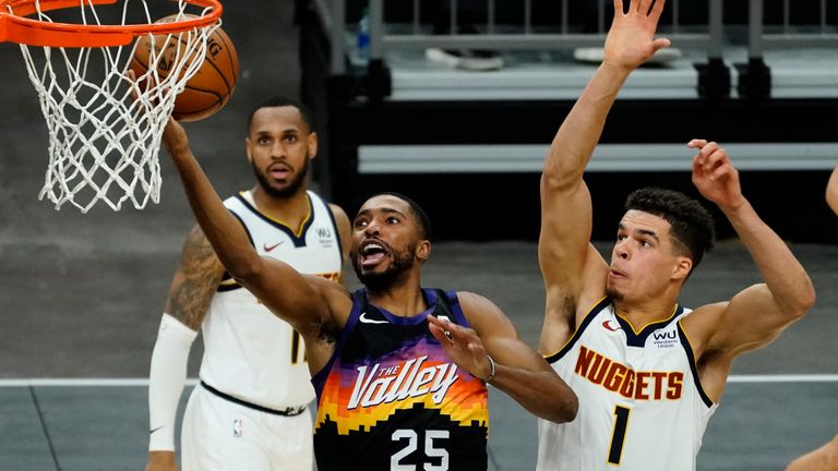 Phoenix Suns forward Mikal Bridges (25) drives past Denver Nuggets forward Michael Porter Jr. (1) during the second half of an NBA basketball game Saturday, Jan. 23, 2021, in Phoenix.