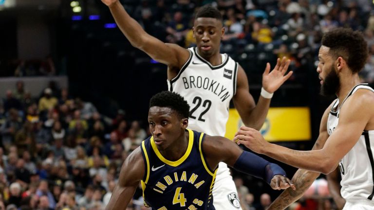 Indiana Pacers guard Victor Oladipo goes through Brooklyn Nets defender Caris LeVert