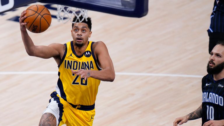 Indiana Pacers guard Jeremy Lamb (26) shoots a layup in front of Orlando Magic guard Evan Fournier (10) during the second half of an NBA basketball game in Indianapolis, Friday, Jan. 22, 2021. (AP Photo/AJ Mast)


