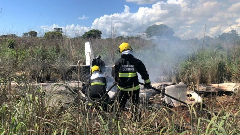 Members of the fire brigade work in the area where a plane crashed near Palmas, Tocantins state, central Brazil, on January 24, 2021