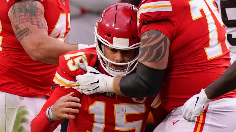 Kansas City Chiefs quarterback Patrick Mahomes is helped off the field by teammate Mike Remmers. (AP Photo/Charlie Riedel)