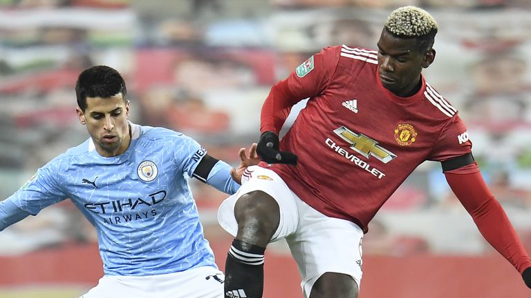 Paul Pogba is challenged by Joao Cancelo during the Carabao Cup semi-final