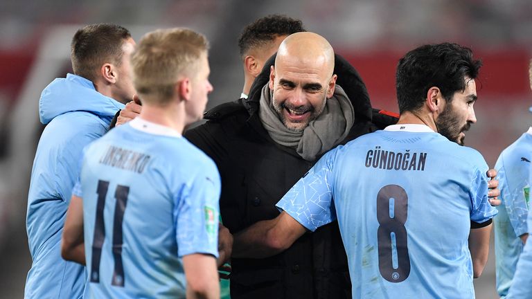 El entrenador en jefe del Manchester City, Pep Guardiola, a la derecha, felicita a sus jugadores después del partido de fútbol de semifinales de la Copa de la Liga inglesa entre Manchester United y Manchester City en Old Trafford en Manchester, Inglaterra, el miércoles 6 de enero de 2021.