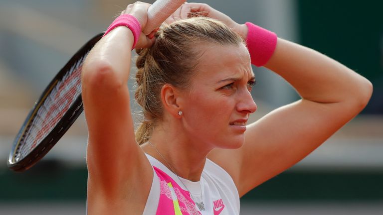 Petra Kvitova of the Czech Republic ties her hair in the semifinal match of the French Open tennis tournament against Sofia Kenin of the U.S. at the Roland Garros stadium in Paris, France, Thursday, Oct. 8, 2020. (AP Photo/Michel Euler)