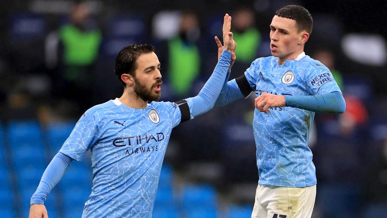 Phil Foden celebrates scoring Man City's third goal against Birmingham with team-mate Bernardo Silva