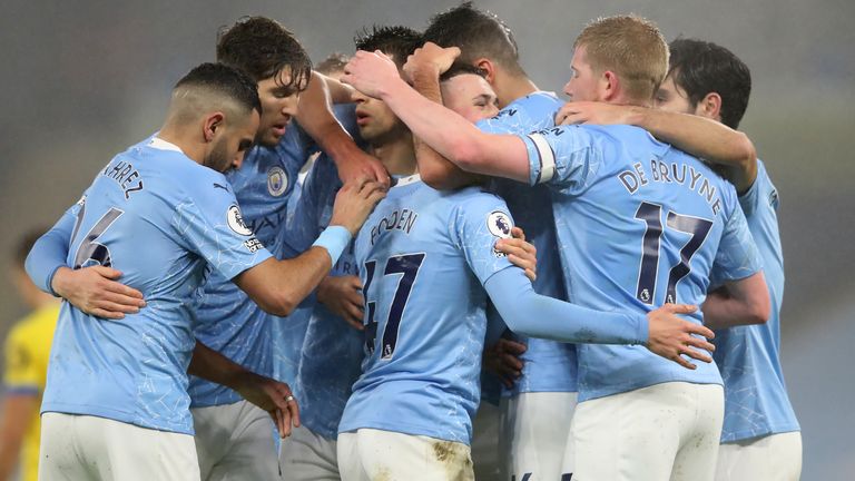 Phil Foden celebrates what proved to be the winning goal against Brighton on Wednesday night with his Manchester City team-mates