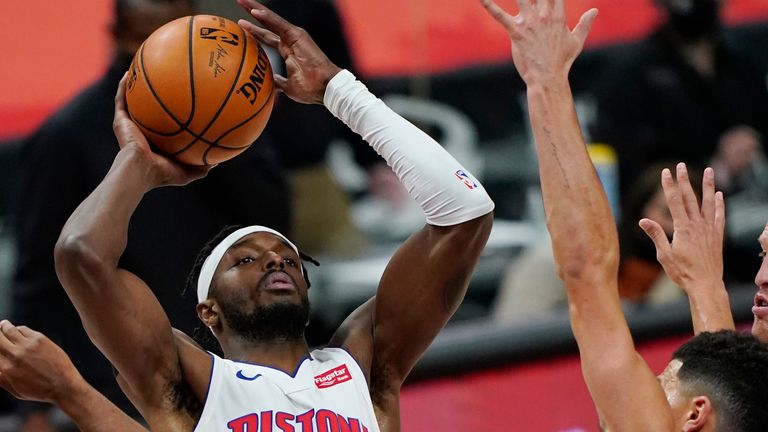 Detroit Pistons forward Jerami Grant shoots over the defense of the Phoenix Suns