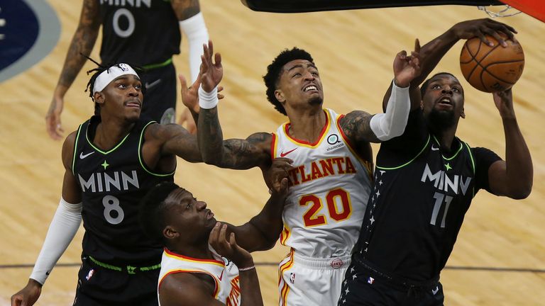Minnesota Timberwolves' Naz Reid (11) grabs a rebound ball against Atlanta Hawks' John Collins (20) during the first half of an NBA basketball game Friday, Jan. 22, 2021, in Minneapolis. (AP Photo/Stacy Bengs)


