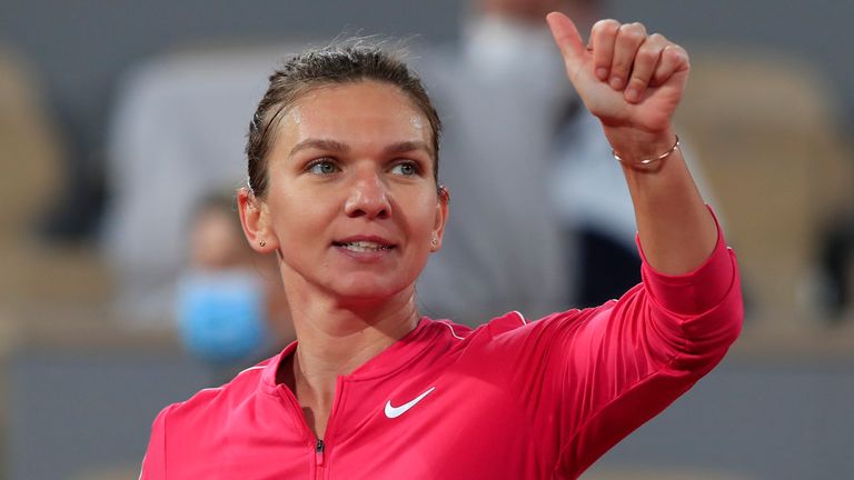 Romania's Simona Halep flashes a thumbs up after winning her third round match of the French Open tennis tournament against Amanda Anisimova of the U.S. in two sets, 6-0, 6-1, at the Roland Garros stadium in Paris, France, Friday, Oct. 2, 2020