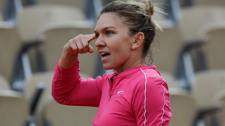 Simona Halep gestures in her match against Romania's Irina-Camelia Begu in the second round of the French Open tennis tournament at the Roland Garros stadium in Paris, France, Wednesday, Sept. 30, 2020