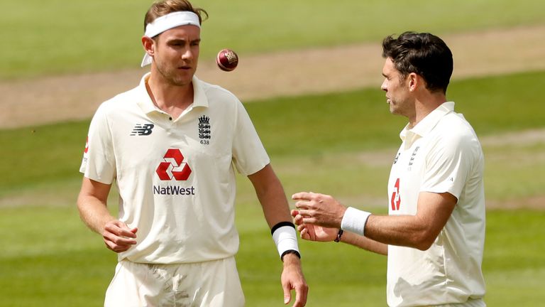 England's Stuart Broad, left, passes the ball to teammate James Anderson during the second day of the first cricket Test match between England and Pakistan at Old Trafford in Manchester, England, Thursday, Aug. 6, 2020. (Lee Smith/Pool via AP)