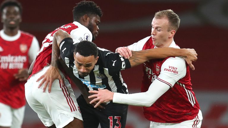 Thomas Partey, left, Arsenal's Rob Holding, right, and Newcastle's Callum Wilson