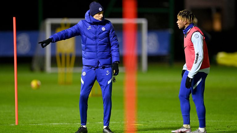 Thomas Tuchel speaks with Reece James during a training session at Cobham