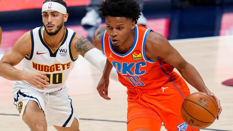 Oklahoma City Thunder forward Josh Hall, right, drives past Denver Nuggets guard Markus Howard during the second half of an NBA basketball game Tuesday, Jan. 19, 2021, in Denver. The Nuggets won 119-101.