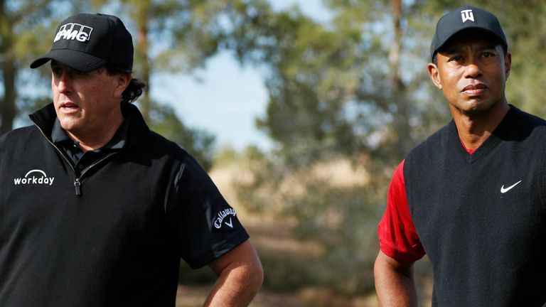 Phil Mickelson and Tiger Woods stand at the first tee before a golf match at Shadow Creek golf course