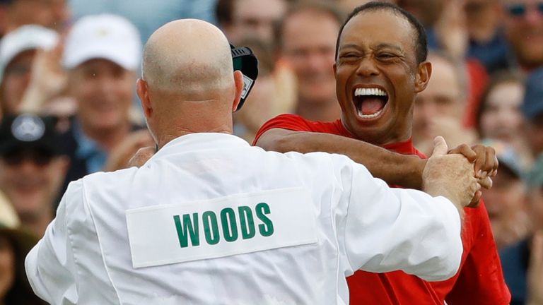 Tiger Woods reacts with his caddie Joe LaCava as he wins the Masters golf tournament Sunday, April 14, 2019, in Augusta, Ga.  (AP Photo/Matt Slocum)