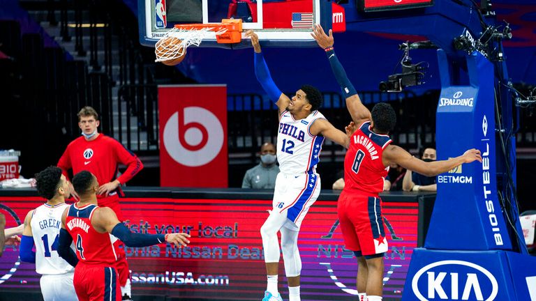 Philadelphia 76ers forward Tobias Harris, left, dunks the ball while being guarded by Washington Wizards forward Rui Hachimura
