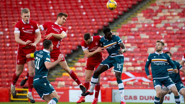 Aberdeen's Tommie Hoban (centre) makes it 1-0 with a header at Pittodrie