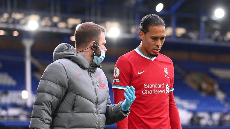 Liverpool&#39;s Virgil van Dijk leaves the game with an injury after a challenge by Everton goalkeeper Jordan Pickford during the Premier League match at Goodison Park, Liverpool.