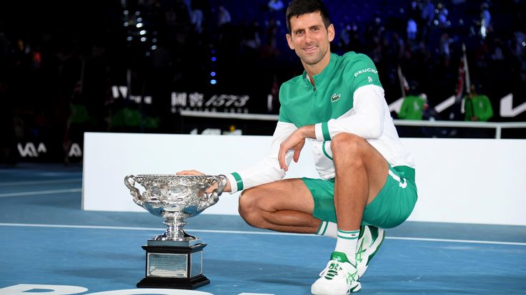 Serbia's Novak Djokovic poses with the Norman Brookes Challenge Cup after defeating Russia's Daniil Medvedev in the men's singles final at the Australian Open tennis championship in Melbourne, Australia, Sunday, Feb. 21, 2021.(AP Photo/Andy Brownbill)