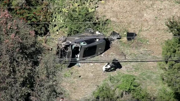 Aerial footage of Tiger Woods' accident shows a car on its side with the front end heavily damaged, while the airbags appeared to be deployed and the wreckage appeared to be just off the side of a road on a hillside