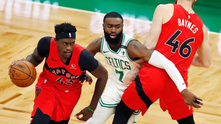 Boston Celtics&#39; Jaylen Brown defends against Toronto Raptors&#39; Pascal Siakam as Aron Baynes provides a screen