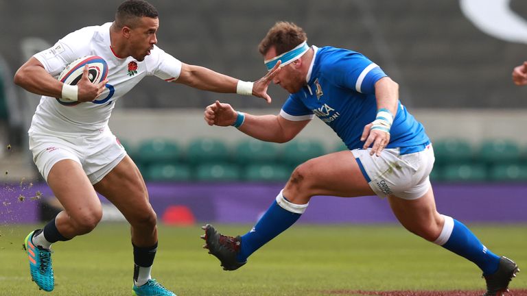 LONDON, ENGLAND - FEBRUARY 13: Anthony Watson of England looks to hand off Andrea Lovotti of Italy during the Guinness Six Nations match between England and Italy at Twickenham Stadium on February 13, 2021 in London, England. Sporting stadiums around the UK remain under strict restrictions due to the Coronavirus Pandemic as Government social distancing laws prohibit fans inside venues resulting in games being played behind closed doors. (Photo by David Rogers/Getty Images)