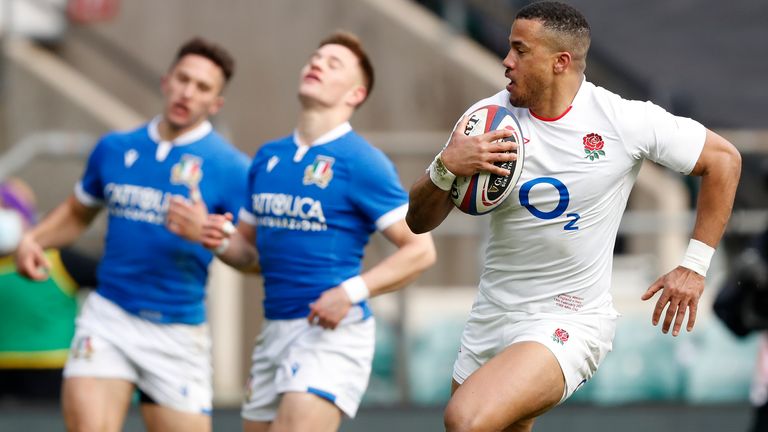 England's Anthony Watson, right, races through to score a try during the Six Nations rugby union international match between England and Italy at Twickenham Stadium in London, Saturday, Feb. 13, 2021. (AP Photo/Alastair Grant)..