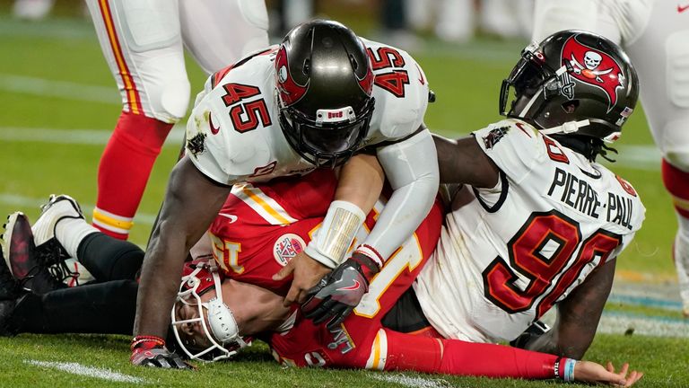 Kansas City Chiefs quarterback Patrick Mahomes, center, is tackled by Tampa Bay Buccaneers inside linebacker Devin White
