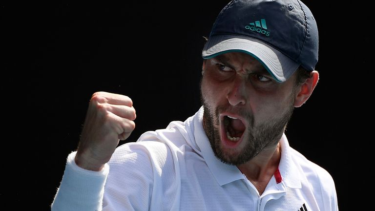 Russia's Aslan Karatsev reacts after winning a point against Bulgaria's Grigor Dimitrov during their quarterfinal match at the Australian Open tennis championship in Melbourne, Australia, Tuesday, Feb. 16, 2021.(AP Photo/Andy Brownbill)