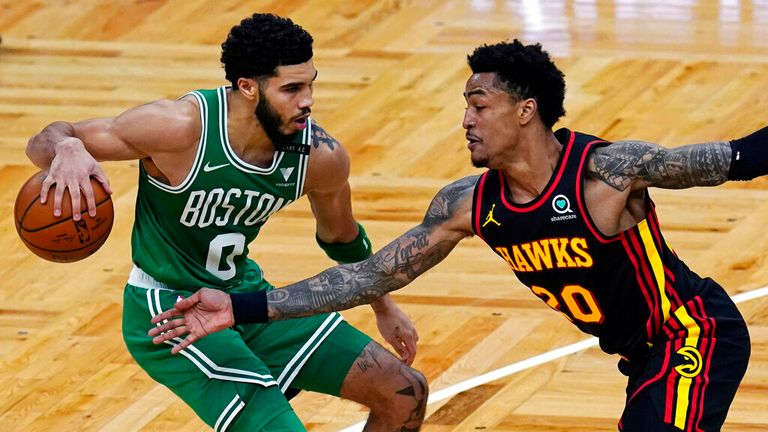 AP - Atlanta Hawks forward John Collins (20) tries to steal the ball against Boston Celtics forward Jayson Tatum (0)