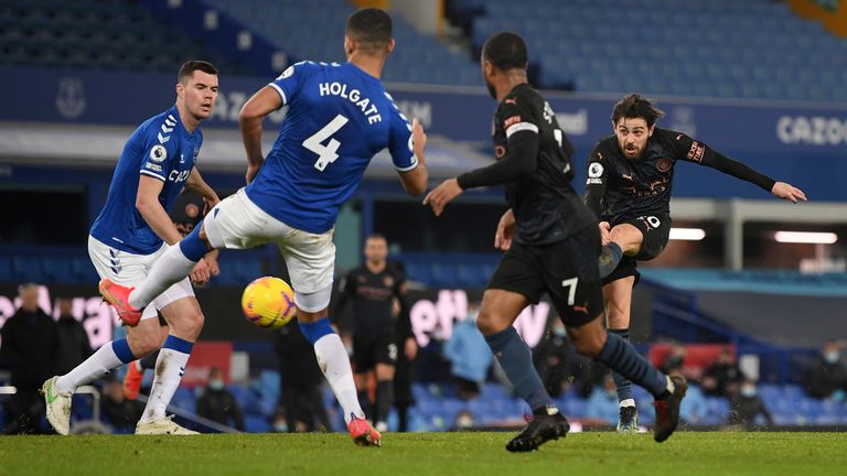 Manchester City's Bernardo Silva, right, scores his side's third goal during the English Premier League soccer match between Everton and Manchester City at Goodison Park stadium, in Liverpool, England, Wednesday, Feb. 17, 2021. (Michael Regan/Pool via AP)