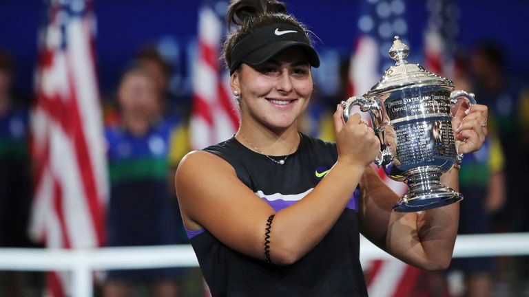 Bianca Andreescu, of Canada, holds up the championship trophy after defeating Serena Williams in the women's singles final of the U.S. Open tennis championships in New York. Reigning U.S. Open champion Bianca Andreescu has pulled out of the Grand Slam tournament. She says the coronavirus pandemic prevented her from properly preparing for competition. (AP Photo/Charles Krupa, FIle)