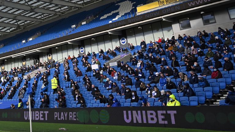 Fans sit socially distanced during the Premier League match between Brighton and Hove Albion and Sheffield United 