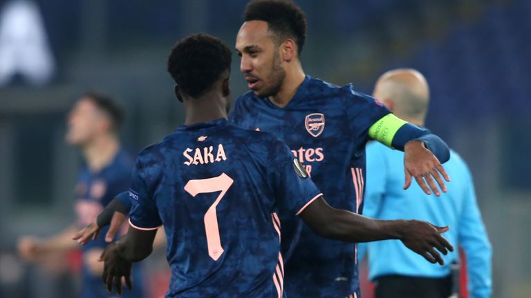 Bukayo Saka celebrates with Pierre-Emerick Aubameyang after equalising against Benfica