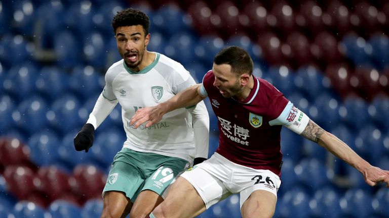 Junior Stanislas puts Phil Bardsley under pressure at Turf Moor on Tuesday