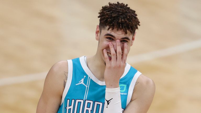 Charlotte Hornets guard LaMelo Ball laughs during a break in the action as his team plays the Minnesota Timberwolves