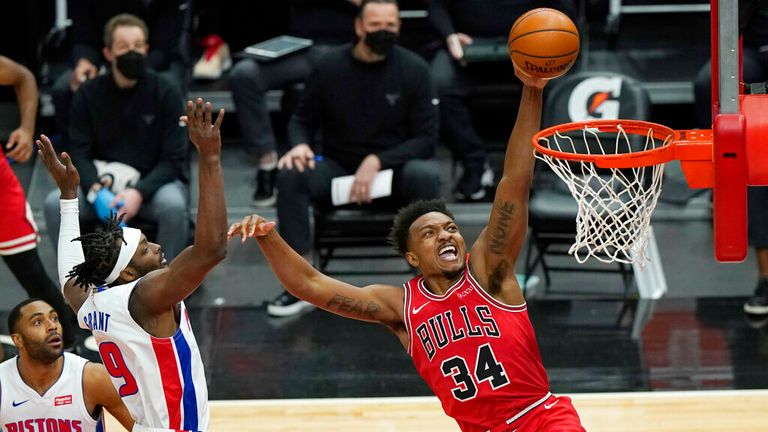 AP - Chicago Bulls center Wendell Carter Jr., right, drives to the basket past Detroit Pistons guard Wayne Ellington