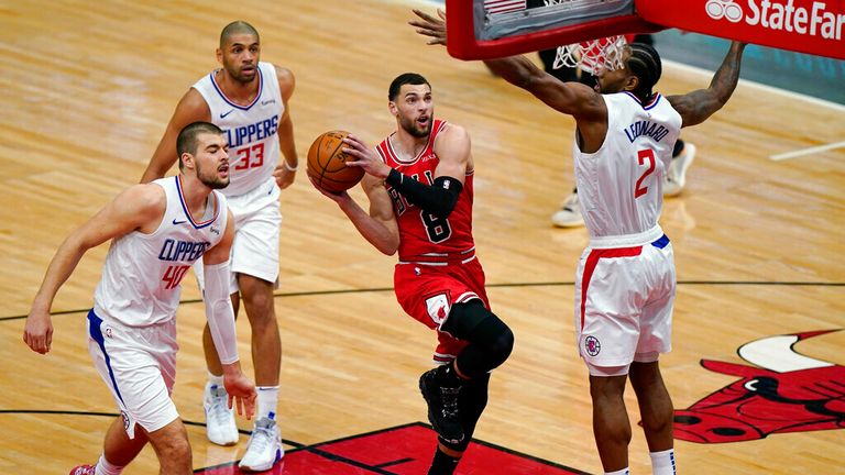 AP - Chicago Bulls guard Zach LaVine (8) drives to the basket against Los Angeles Clippers center Ivica Zubac, left, forward Nicolas Batum