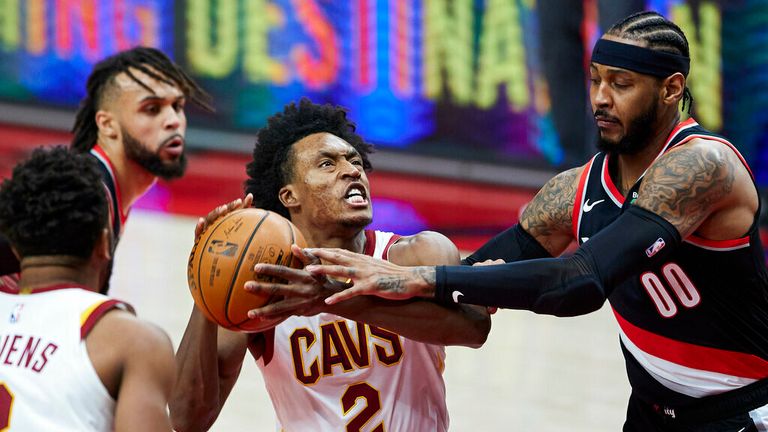 AP - Cleveland Cavaliers guard Collin Sexton, left, is fouled by Portland Trail Blazers forward Carmelo Anthony