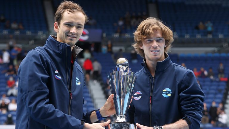 Russia's ATP Cup winners Daniil Medvedev, and Andrey Rublev, right, pose with their trophy after defeating Italy in the final in Melbourne, Australia, Sunday, Feb. 7, 2021.(AP Photo/Hamish Blair)