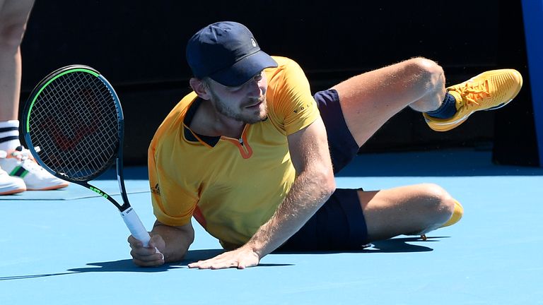 Belgium's David Goffin falls during his first round match against Australia's Alexei Popyrin at the Australian Open tennis championship in Melbourne, Australia, Tuesday, Feb. 9, 2021.(AP Photo/Andy Brownbill)