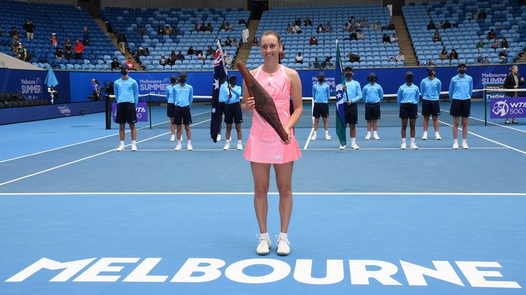 Belgium's Elise Mertens holds her trophy after defeating Estonia's Kaia Kanepi in the final of the Gippsland Trophy in Melbourne, Australia, Sunday, Feb. 7, 2021.(AP Photo/Andy Brownbill)