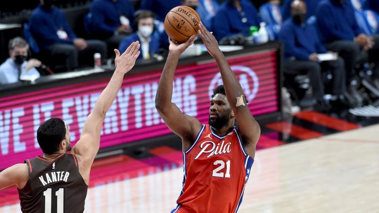 Philadelphia 76ers center Joel Embiid hits a shot over Portland Trail Blazers center Enes Kanter