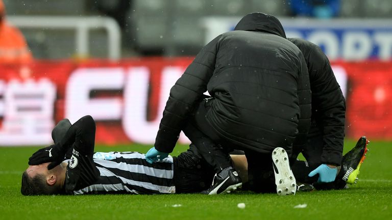 Newcastle's Fabian Schar receives medical treatment after picking up an injury