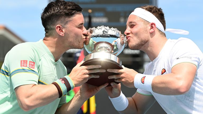 Gordon Reid of Great Britain and Alfie Hewett of Great Britain kiss the championship trophy after winning the Men's Wheelchair Doubles Final against Stephane Houdet of France and Nicolas Peifer of France during day nine of the 2021 Australian Open at Melbourne Park on February 16, 2021 in Melbourne, Australia. (Photo by Quinn Rooney/Getty Images)