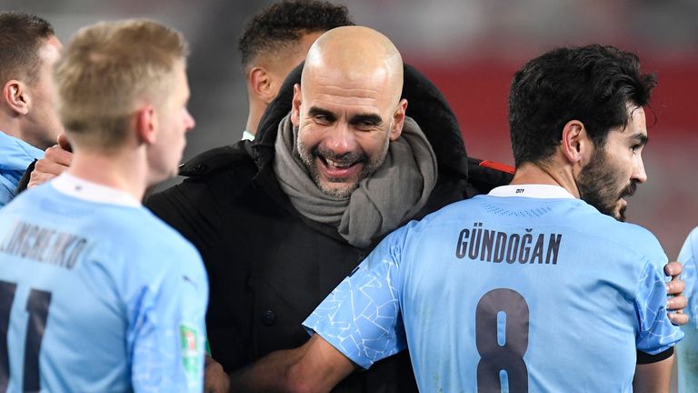 Manchester City&#39;s head coach Pep Guardiola, right, congratulates his players after the English League Cup semifinal soccer match between Manchester United and Manchester City at Old Trafford in Manchester, England, Wednesday, Jan. 6, 2021. (Peter Powell/Pool via AP)