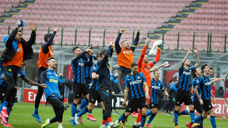 Inter players celebrate their 3-0 win at the end of the Serie A soccer match between AC Milan and Inter Milan, at the Milan San Siro Stadium, Italy, Sunday, Feb. 21, 2021. (AP Photo/Antonio Calanni)