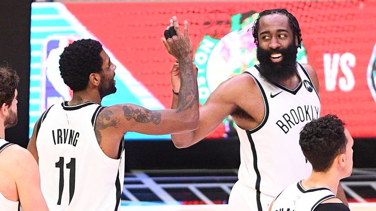 Brooklyn Nets James Harden and Kyrie Irving give high fives in the final minute of a NBA game between the Brooklyn Nets and the Los Angeles Clippers