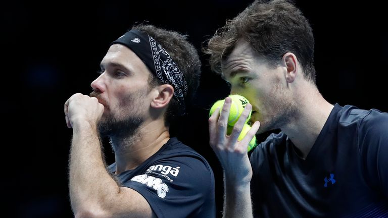Jamie Murray of Britain, right, and Bruno Soares of Brazil talk tactics before serving to Juan Sebastian Cabal of Colombia and Robert Farah of Colombia during their ATP World Tour Finals men's doubles tennis match at the O2 arena in London, Tuesday, Nov. 13, 2018. (AP Photo/Alastair Grant)